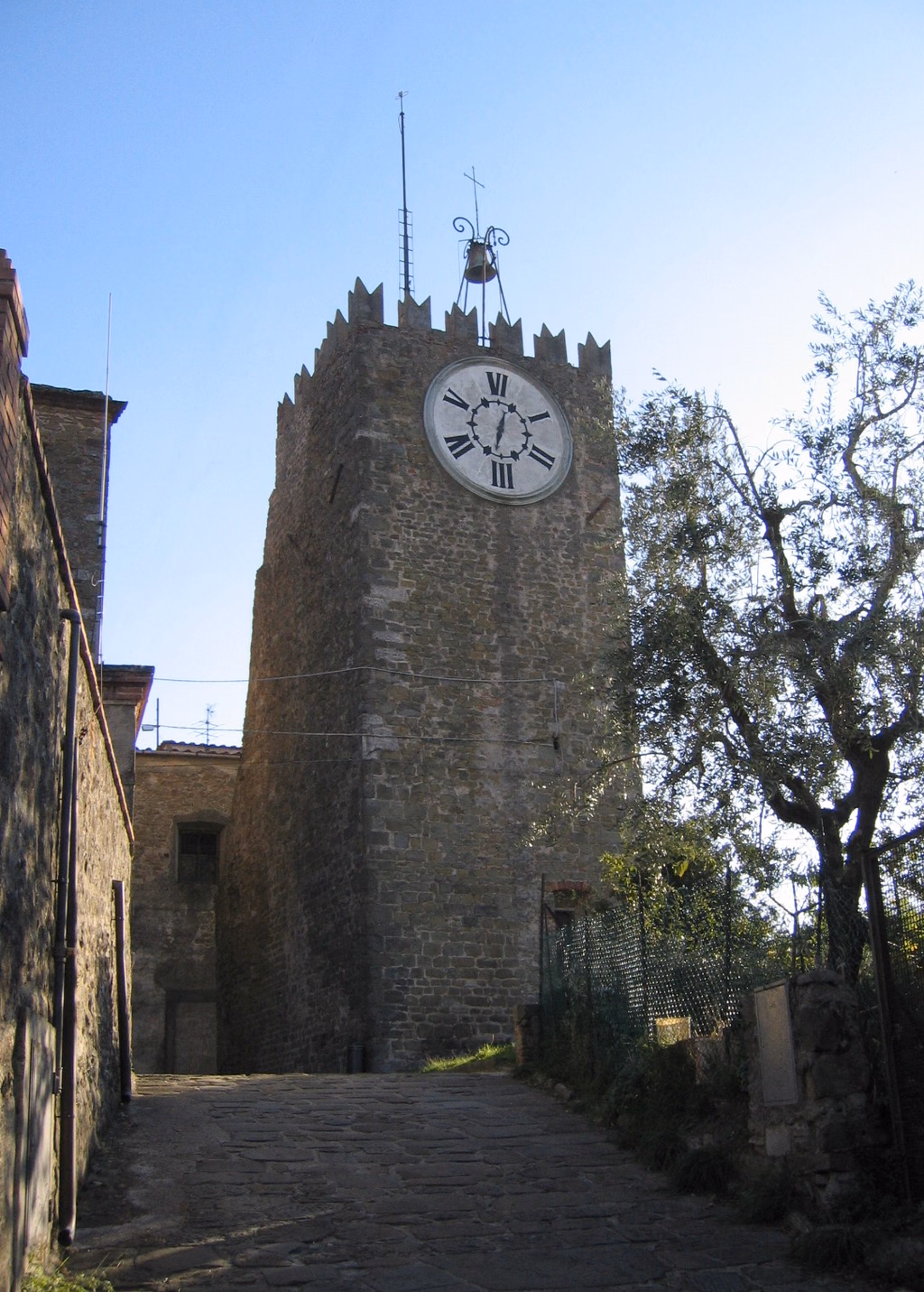 The medieval Torre dell’Orologio above a stone lane in Montecatini Alto