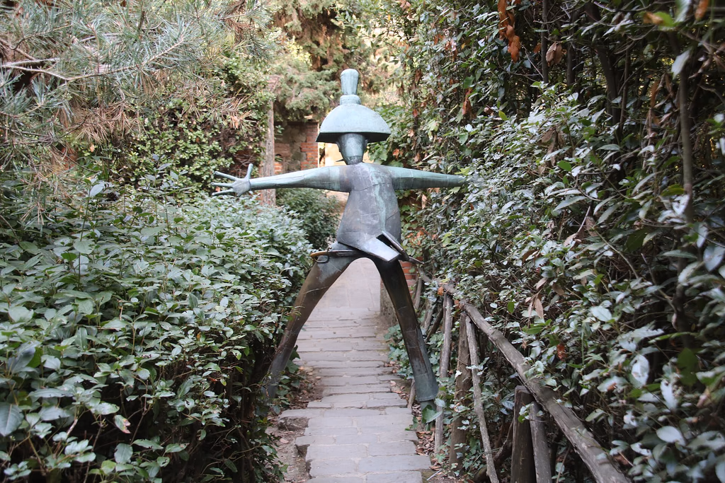 A colourful Carabiniere sculpture among the trees in Pinocchio Park