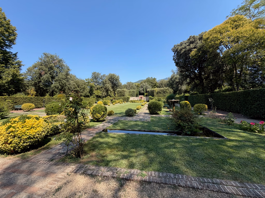 Clipped hedges, rose beds and reflecting pools in a formal garden at Villa Reale